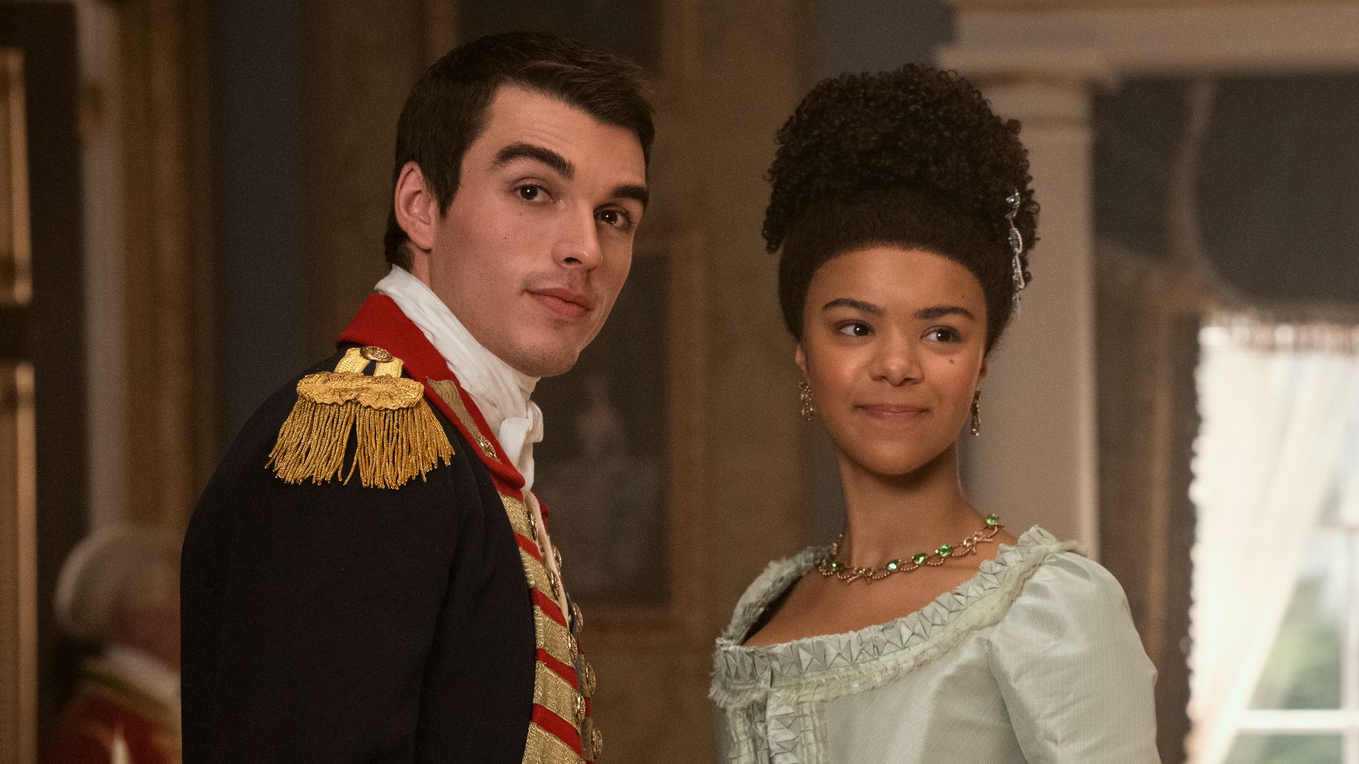 man and woman in period clothing standing in house