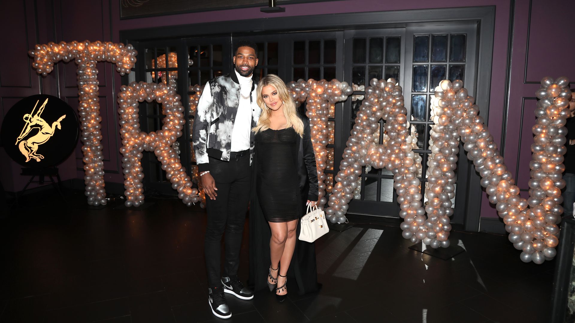 Khloe and Tristan Thompson stood in front of a balloon sculpture which reads 'Tristan'