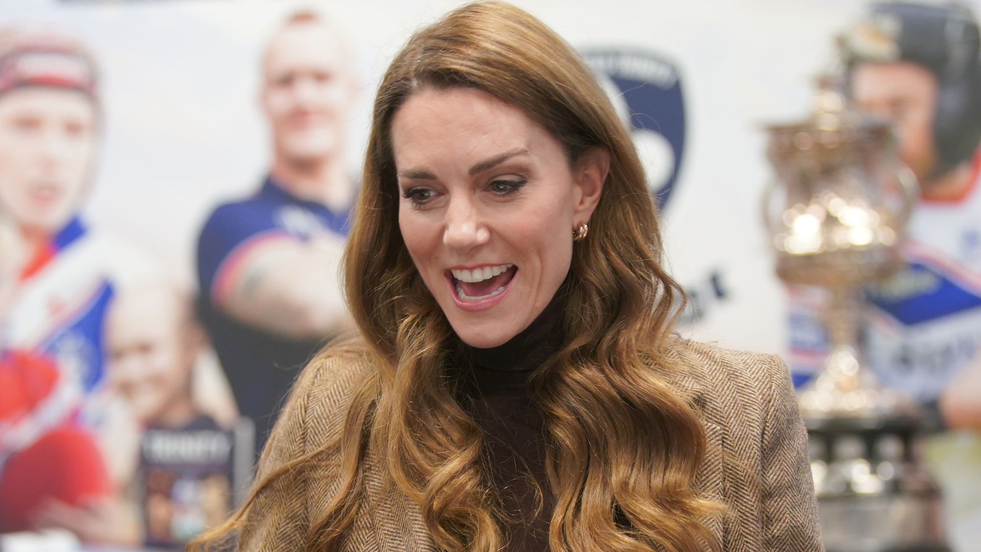 Kate Middleton speaking in a coat