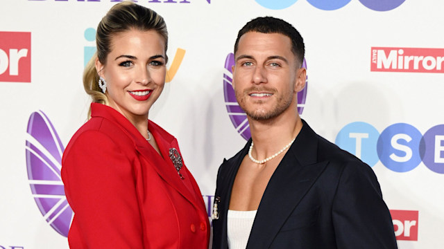 Gemma Atkinson in a red dress standing with Gorka Marquez in a black suit