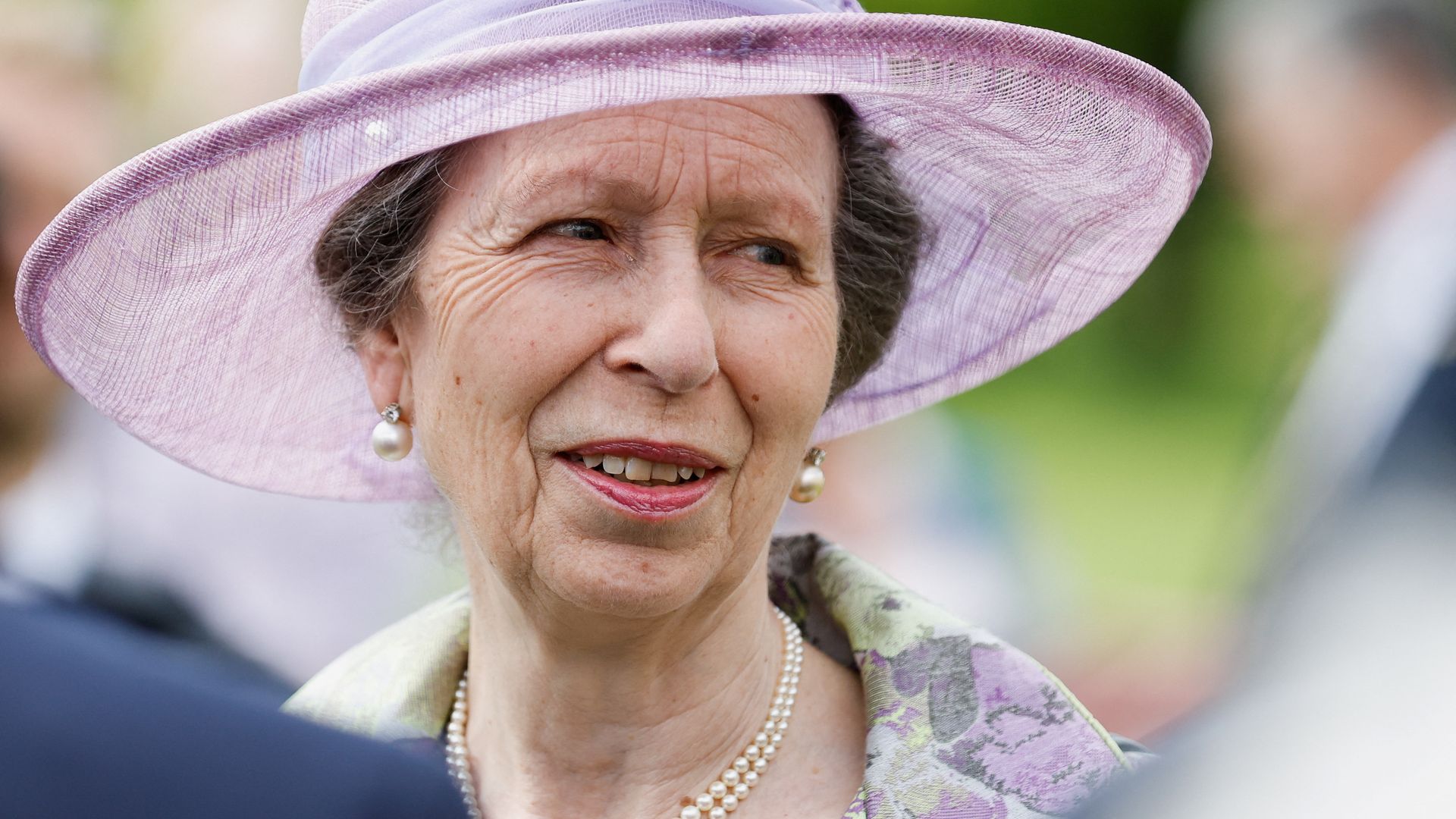 Princess Anne wearing hat and pearls at garden party