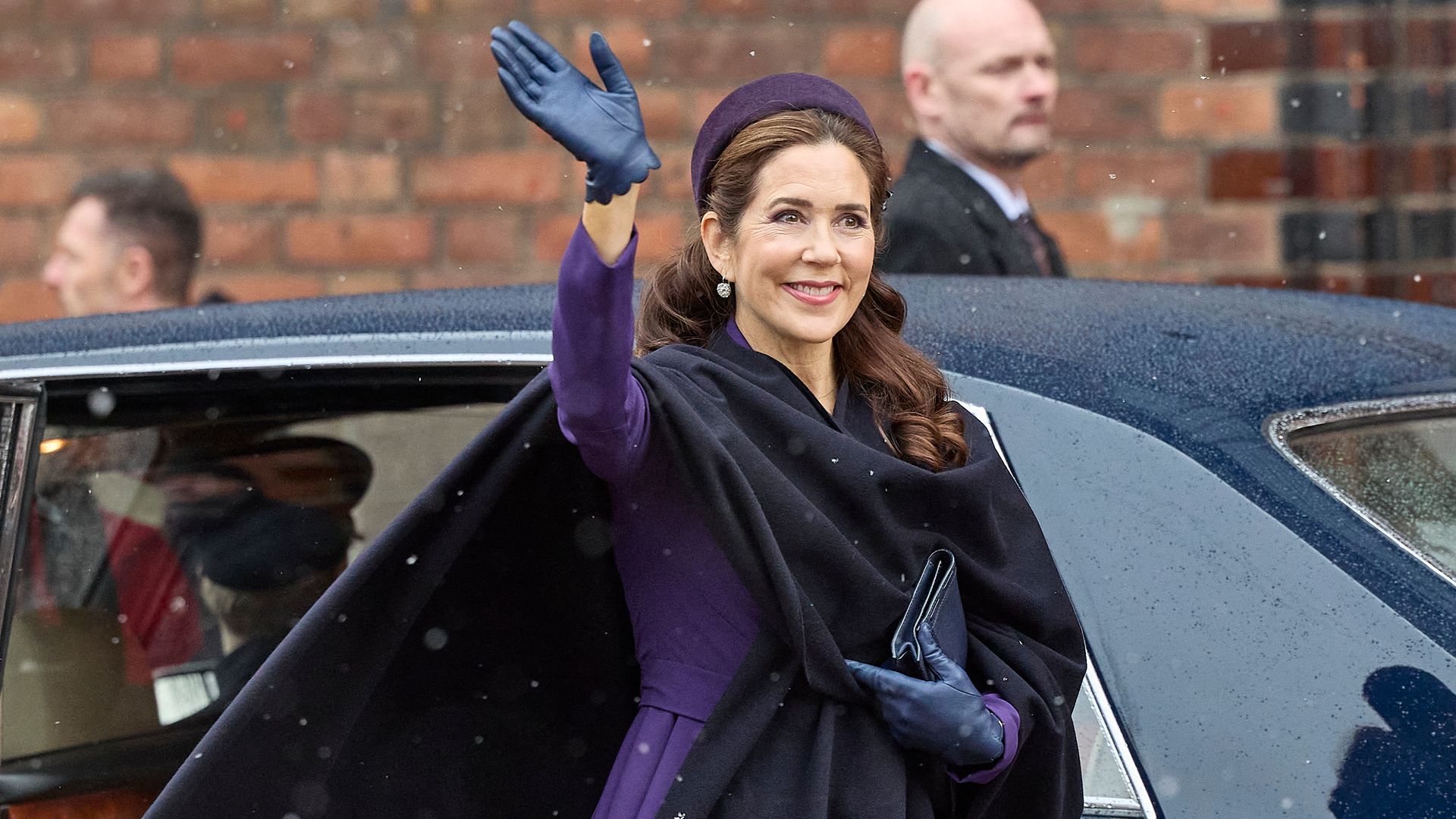 Queen Mary of Denmark greets the crowd as she arrives to a church service on the occasion of the change of throne in Denmark, in Aarhus Cathedral, on January 21, 2024