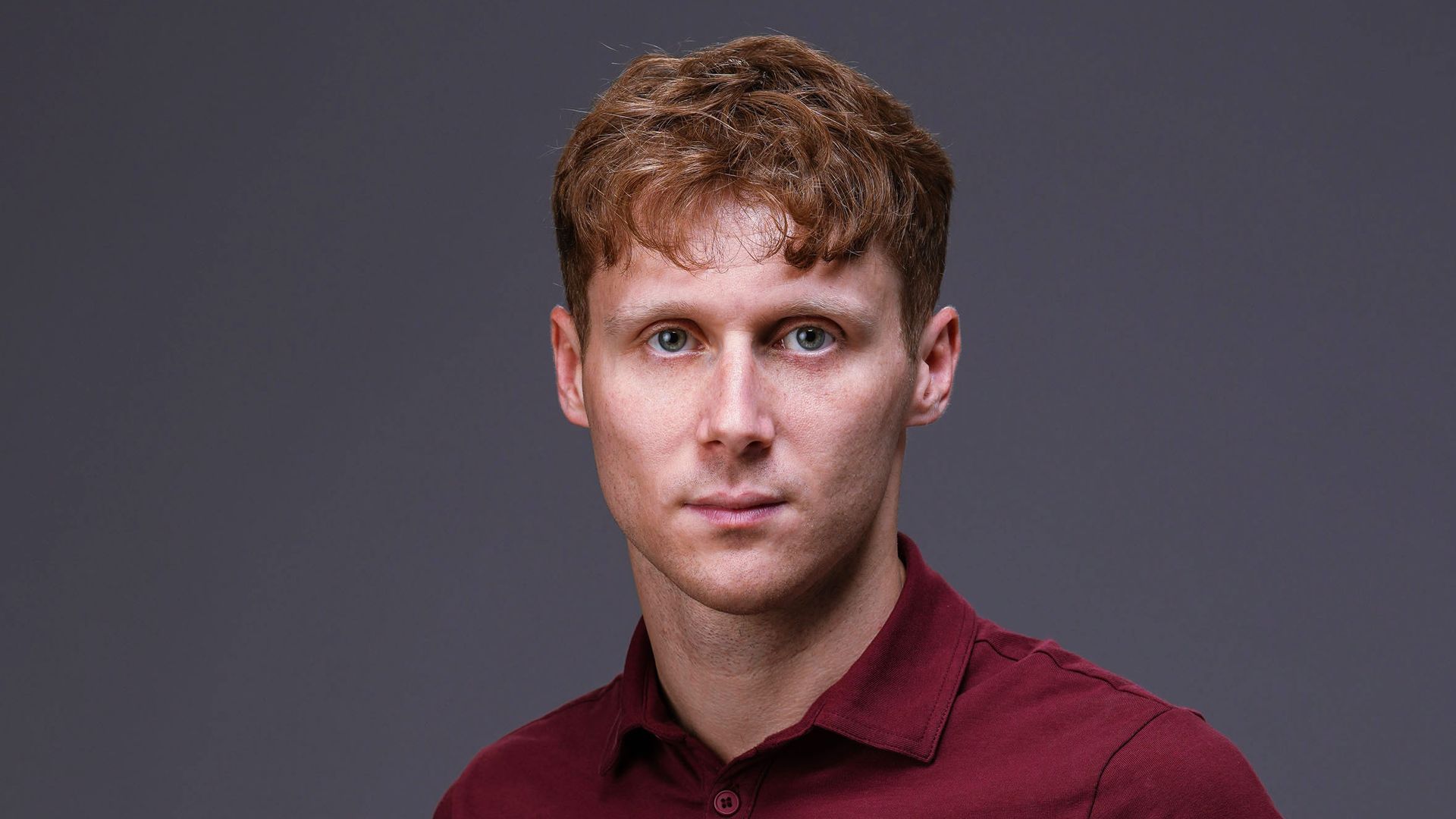 A man stands with his hands in his pockets