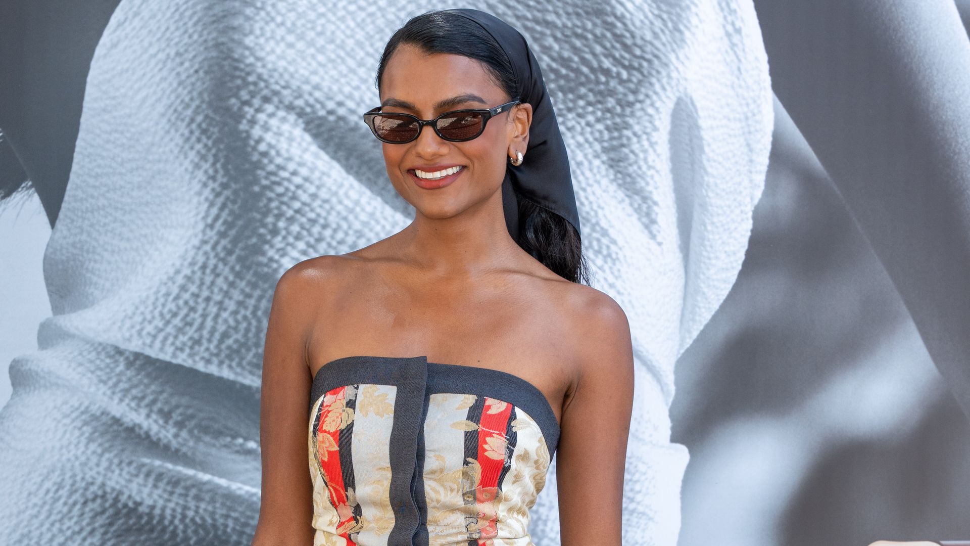 Simone Ashley is seen at Hotel Martinez during day twelve of the 78th Cannes Film Festival in printed dress