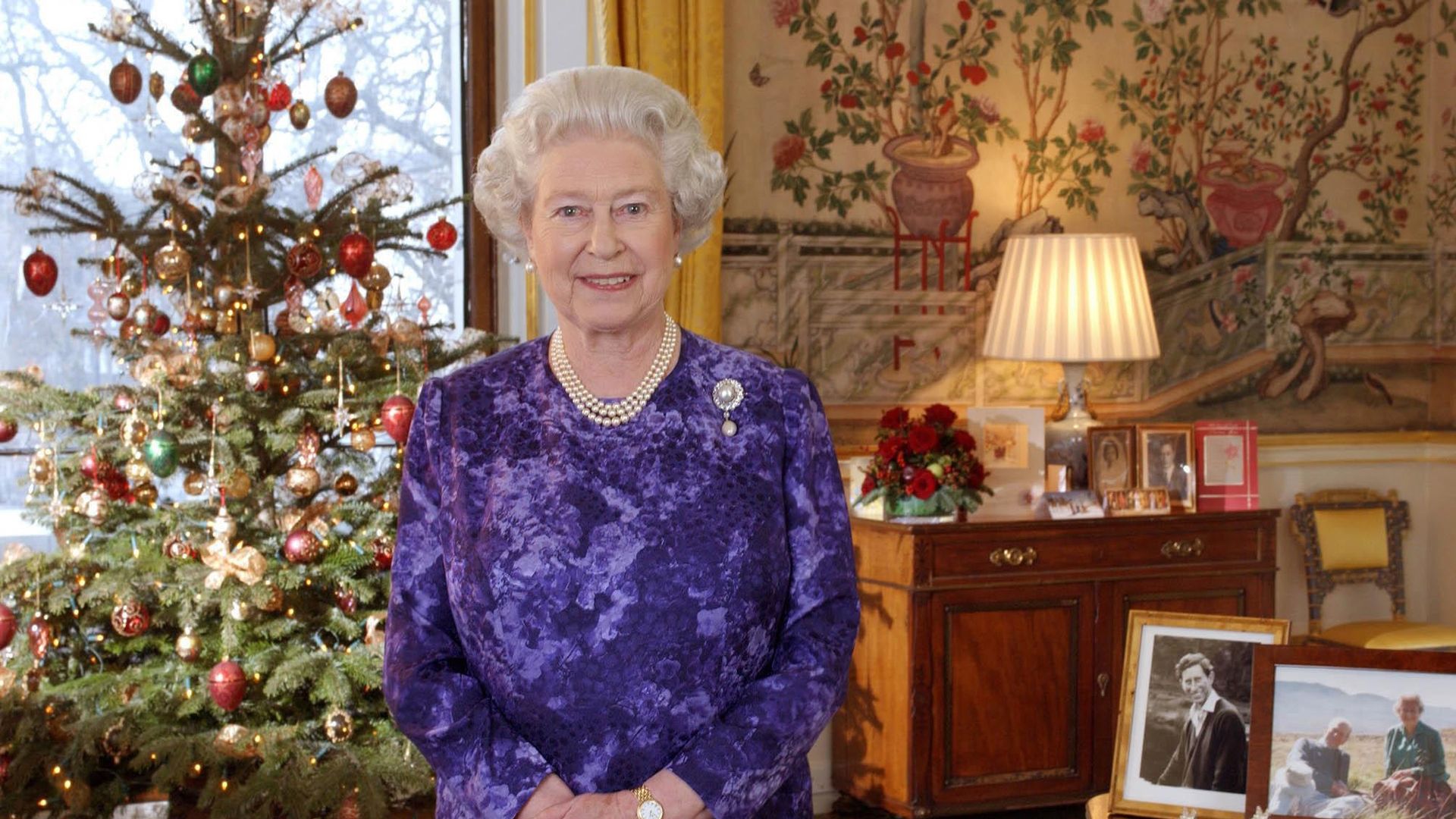 The Queen inside the Yellow Drawing Roomby family portraits and a Christmas tree