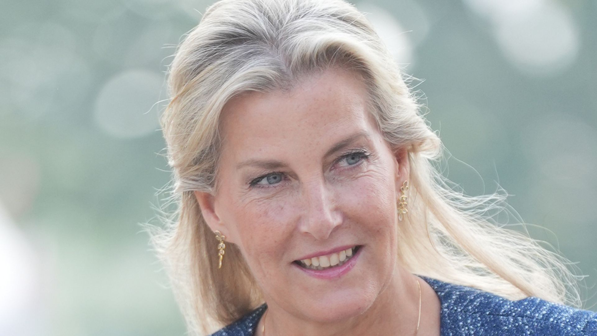 The Duchess of Edinburgh looking to right in navy trousers and jacket