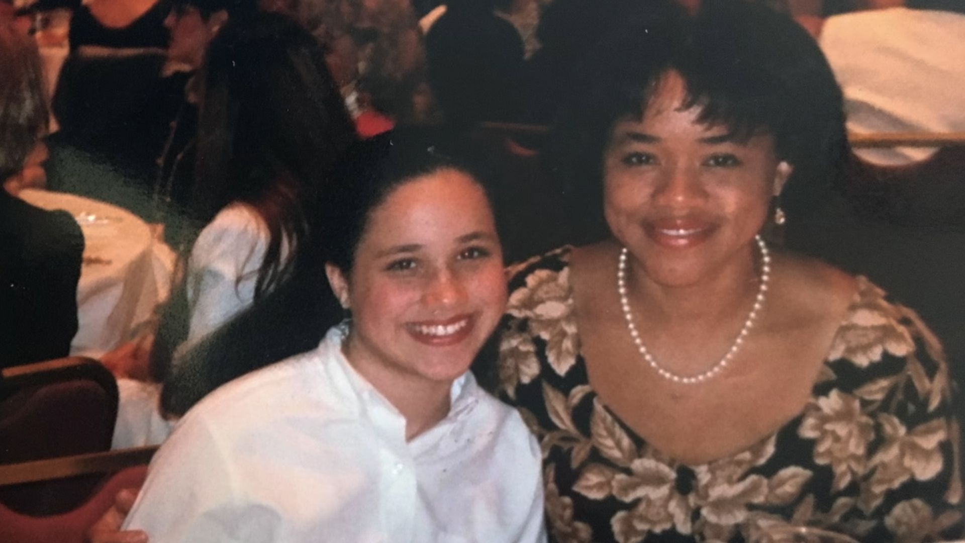 A young Meghan Markle and Doria Ragland at a dinner