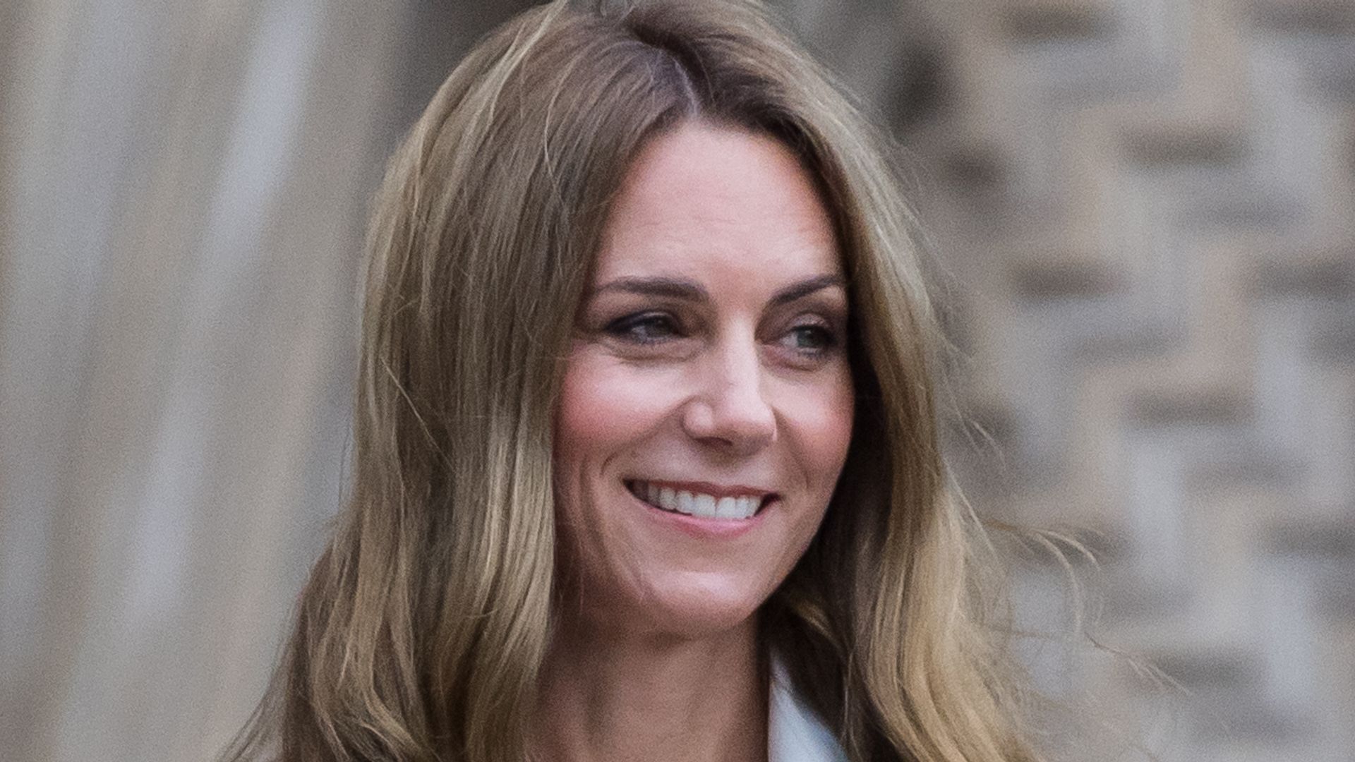 Kate Middleton smiling with blonde curls