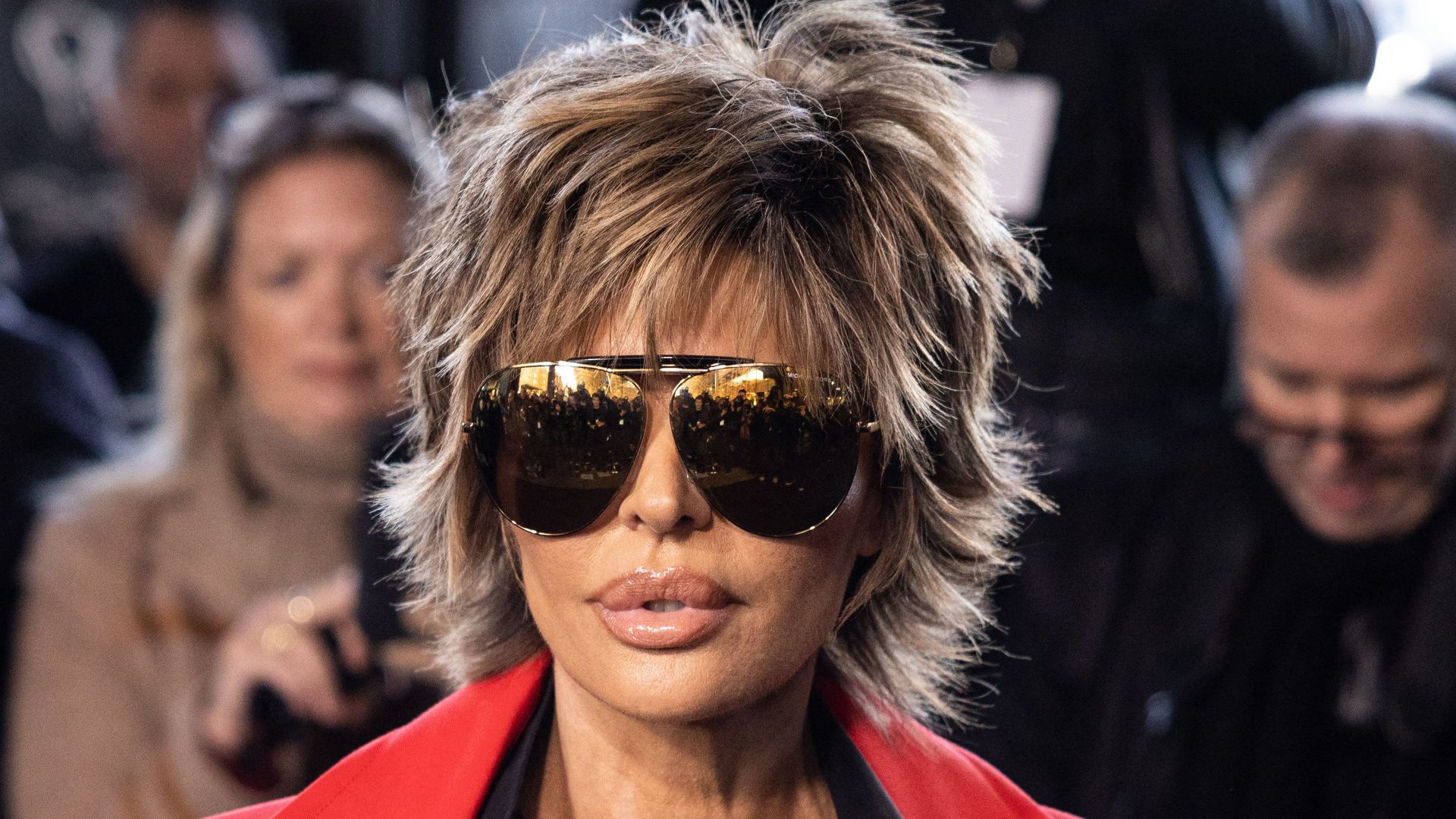 Lisa Rinna in sunglasses and red coat