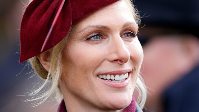 Zara Tindall attends day 2 'Style Wednesday' of the Cheltenham Festival at Cheltenham Racecourse on March 12, 2025 in London, England, wearing a burgundy hat.