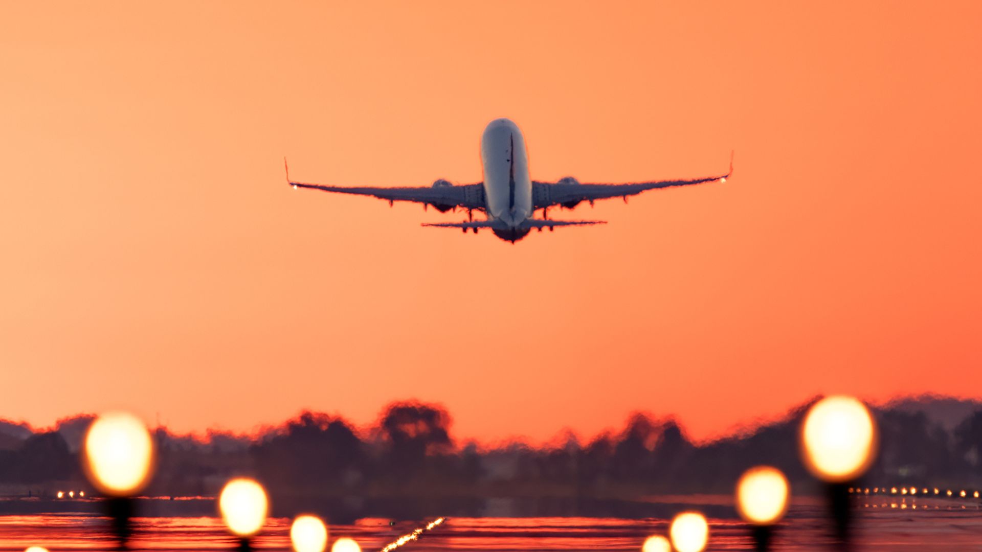 Airplane taking off at sunrise, travel and tourism