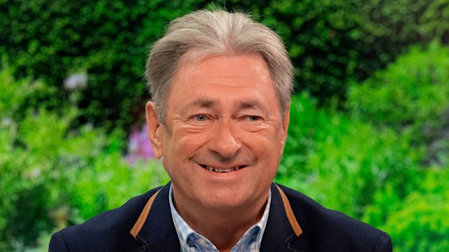 Man in suit smiling in TV studio