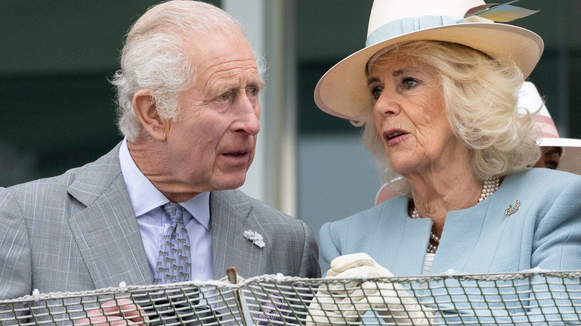 King Charles and Queen Camilla looking concerned