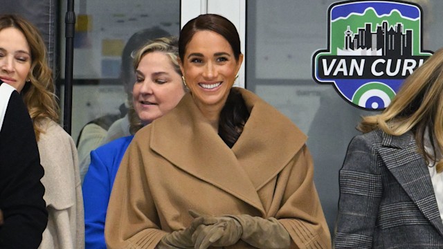 Meghan Markle smiling in camel coat