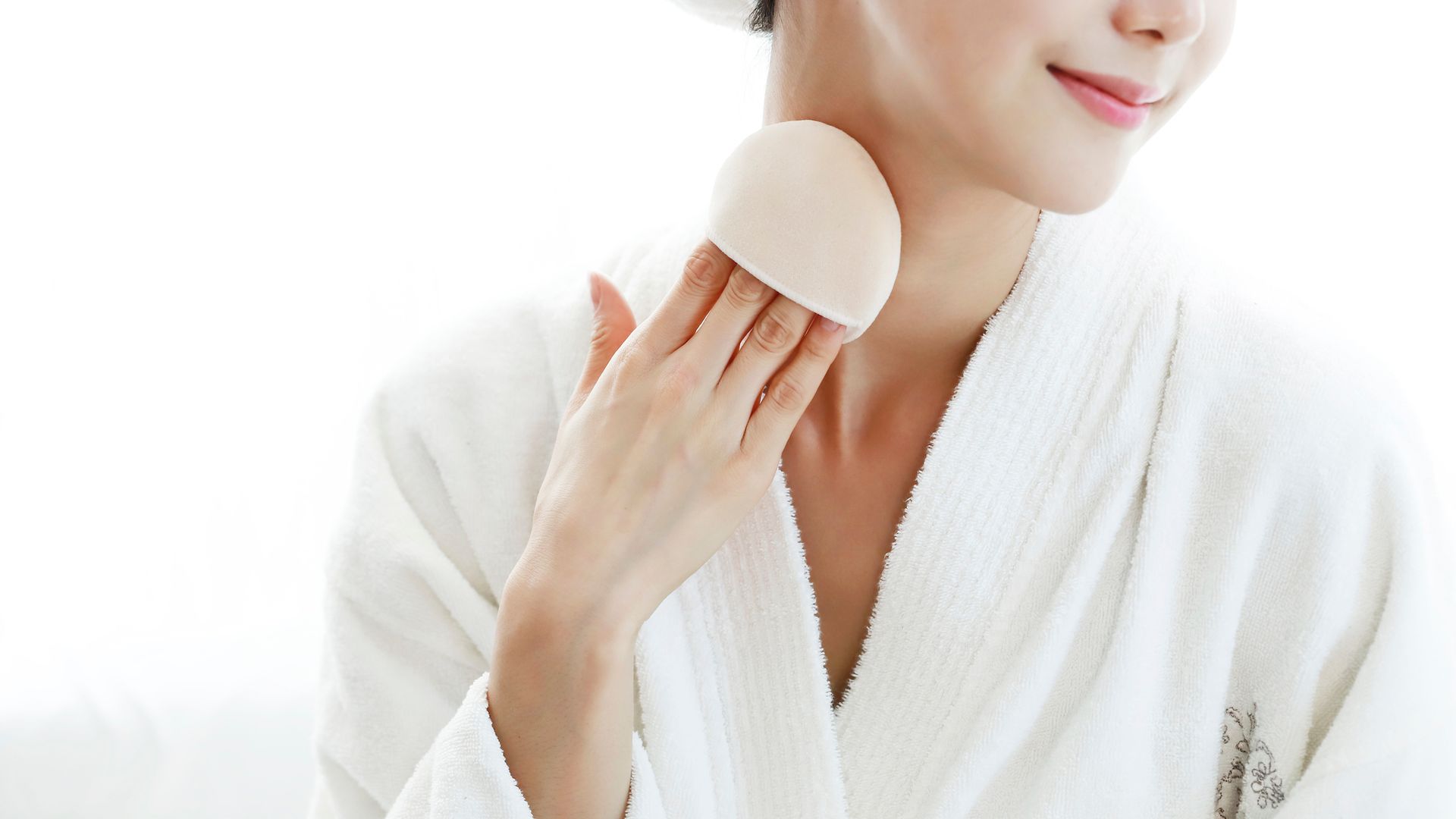 a woman applying body powder 