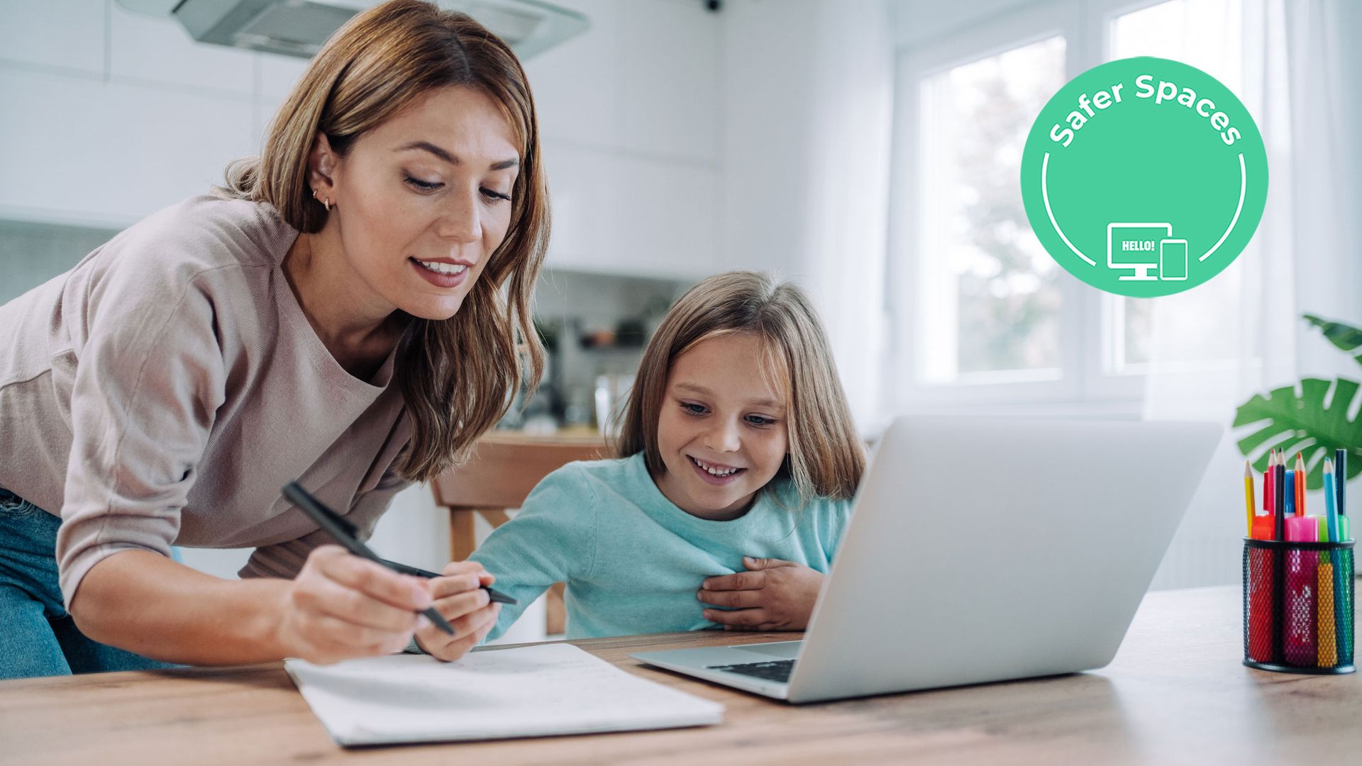 girl using laptop with mum