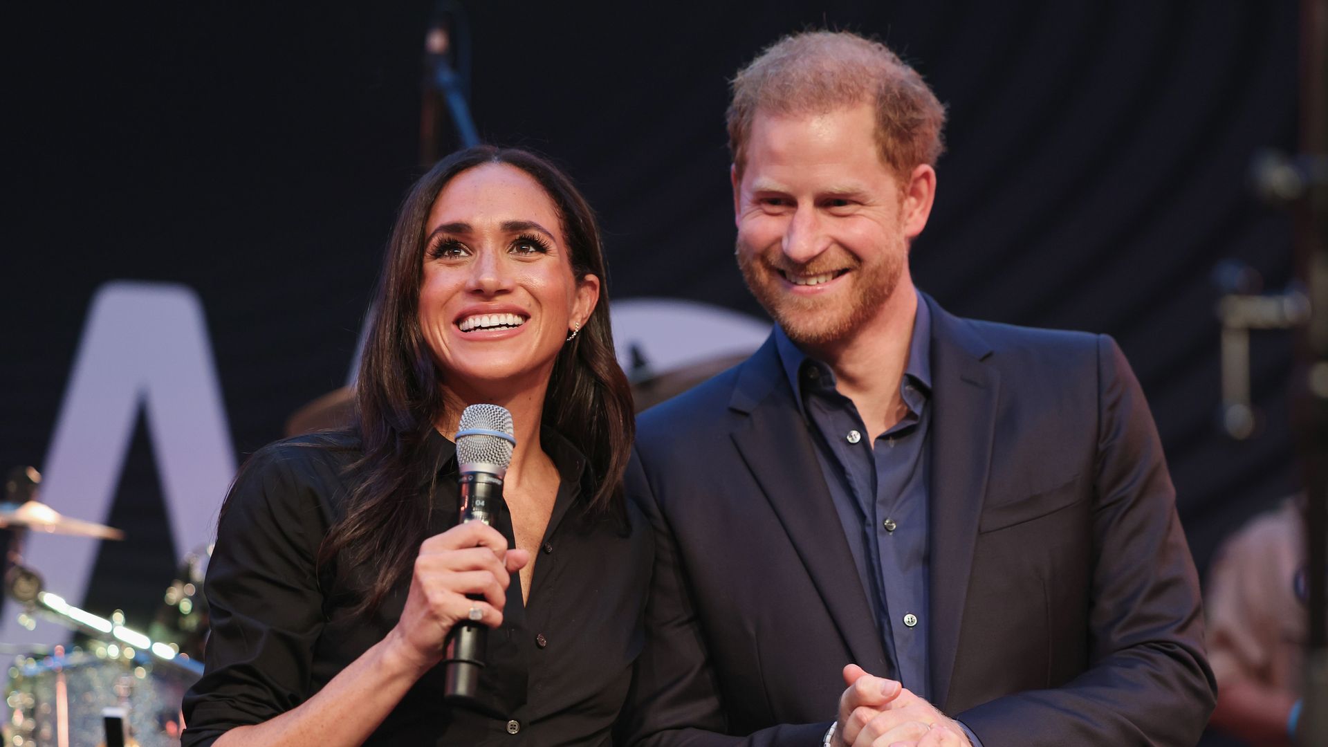 Harry and Meghan on stage at the Friends @ Home Event in Dusseldorf