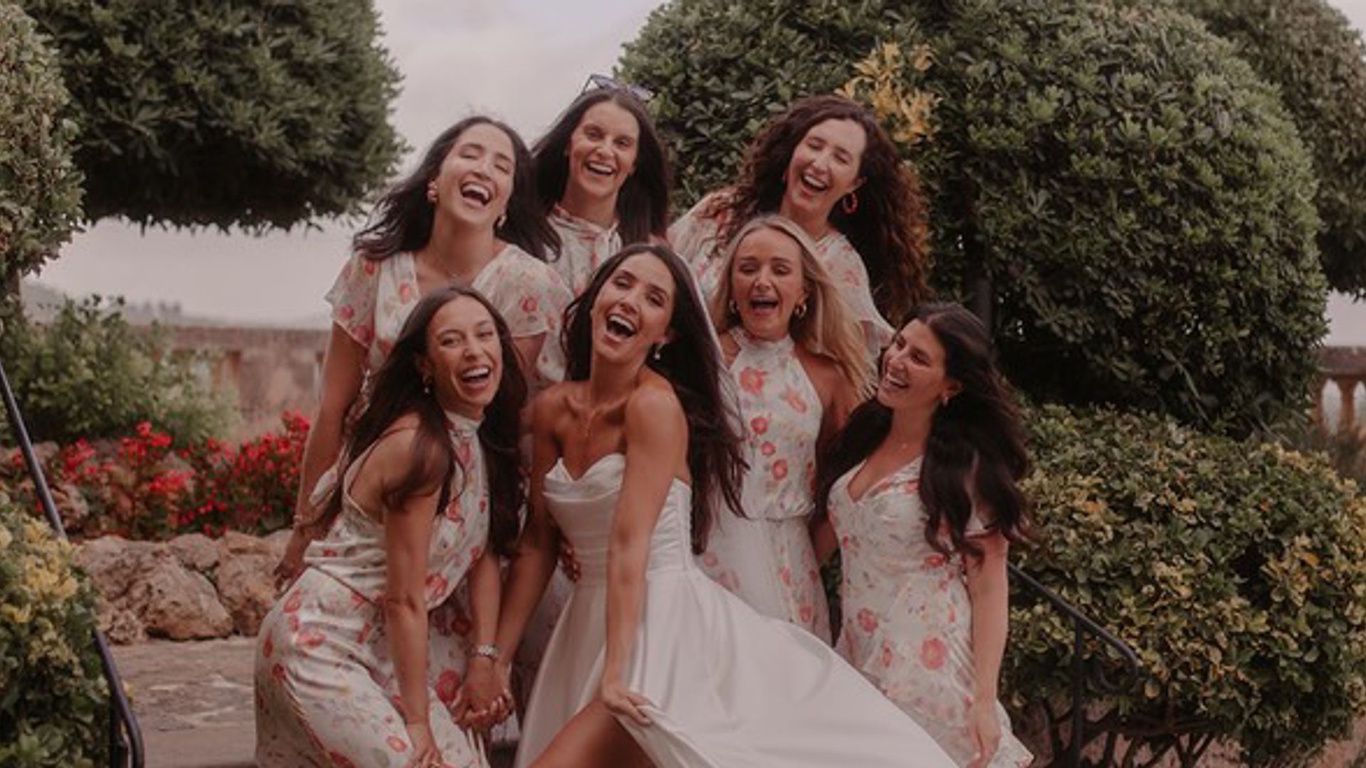 Josie May Mitchell wearing a Pronovias wedding dress with bridesmaids wearing floral bridesmaid dresses from Rixo