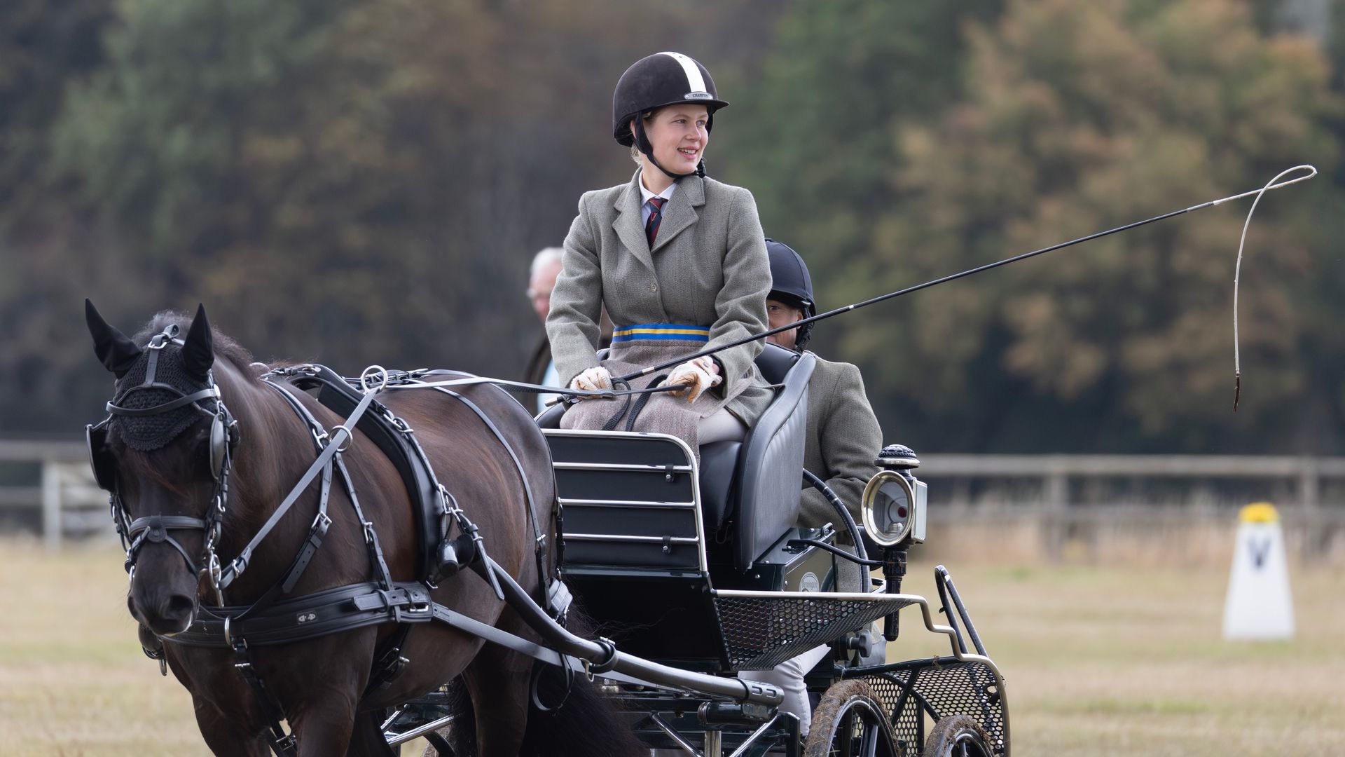 Lady Louise Windsor smiling as she drives a carriage