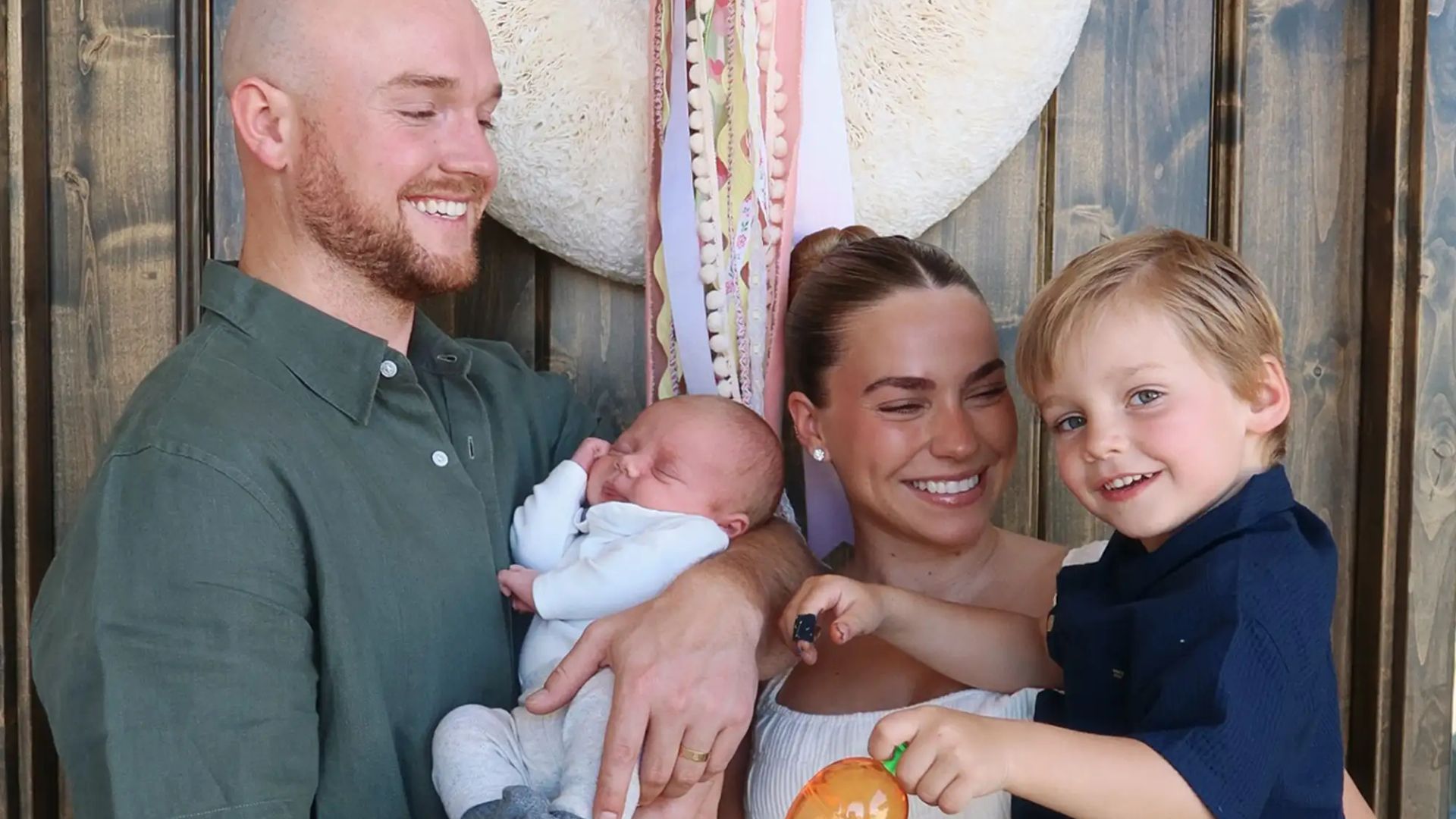 Emilie Kiser poses with her son Trigg (R) and husband Blake (L) who holds their son Theodore