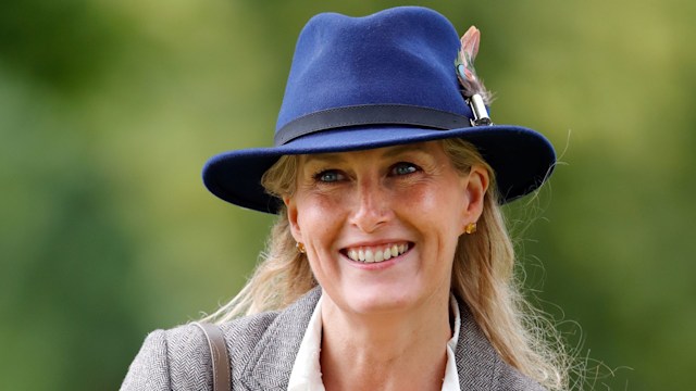 Sophie smiling in blue hat and grey blazer