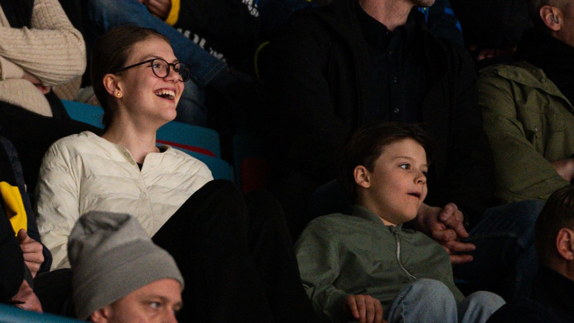 Princess Estelle and Prince Gabriel smiling while watching a hockey match