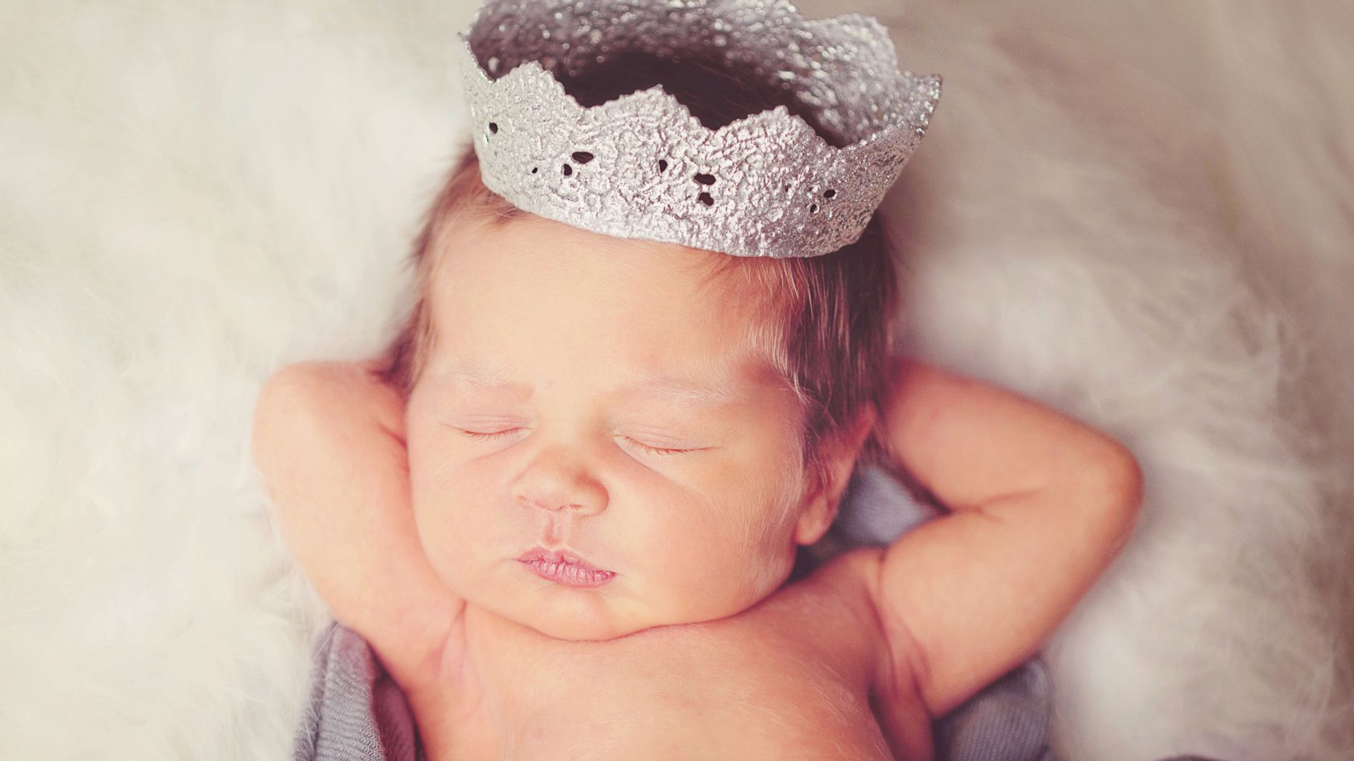 newborn baby wearing silver crown