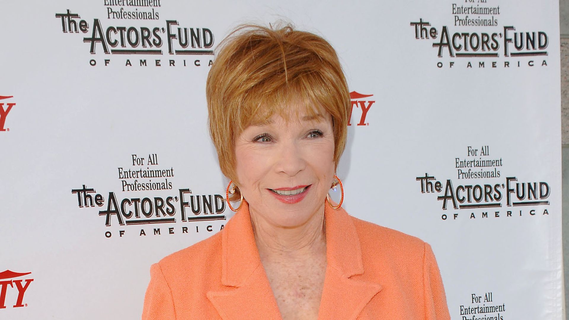 shirley maclaine orange suit