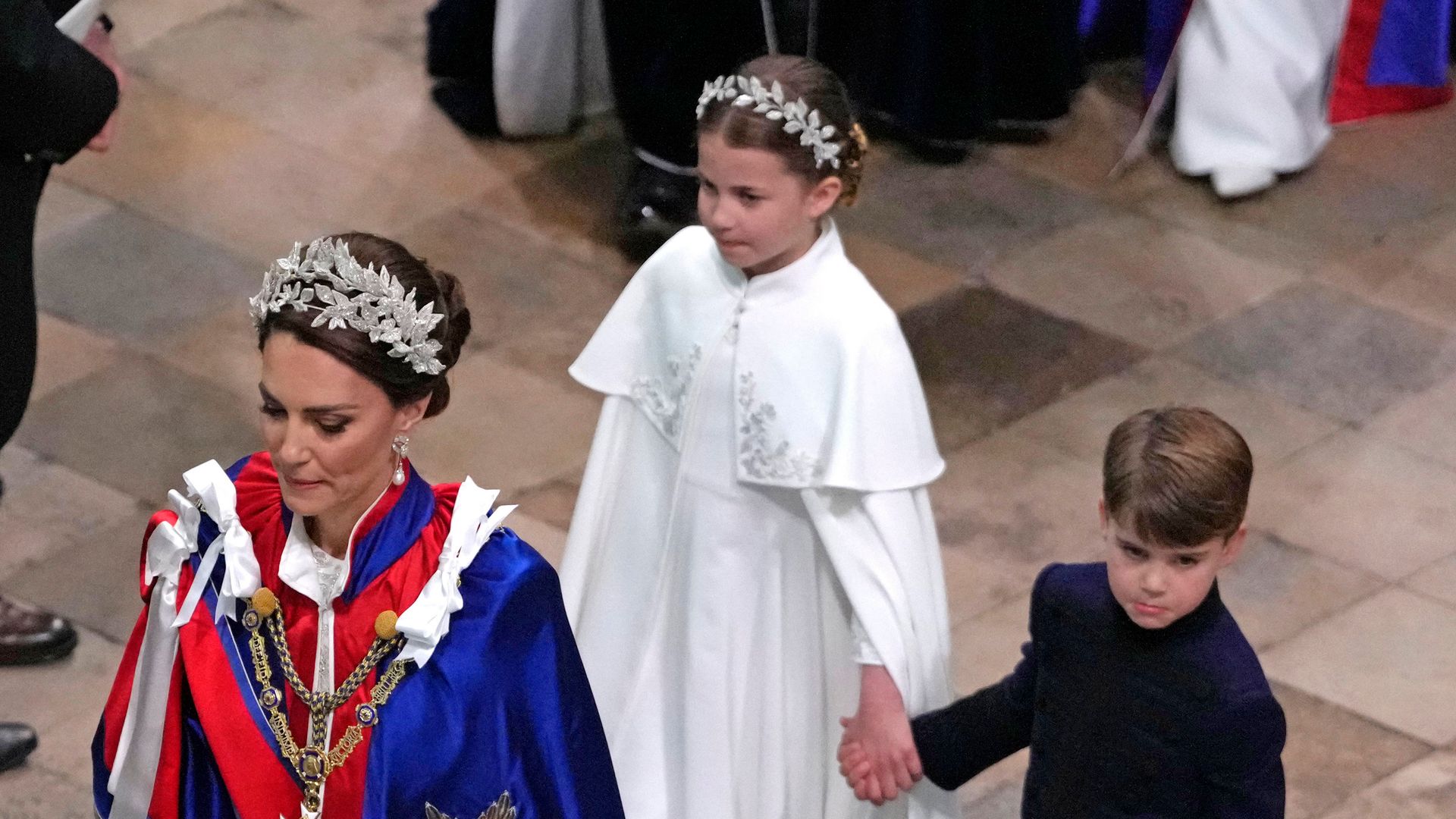 Princess Kate walking with Princess Charlotte and Prince Louis at the coronation