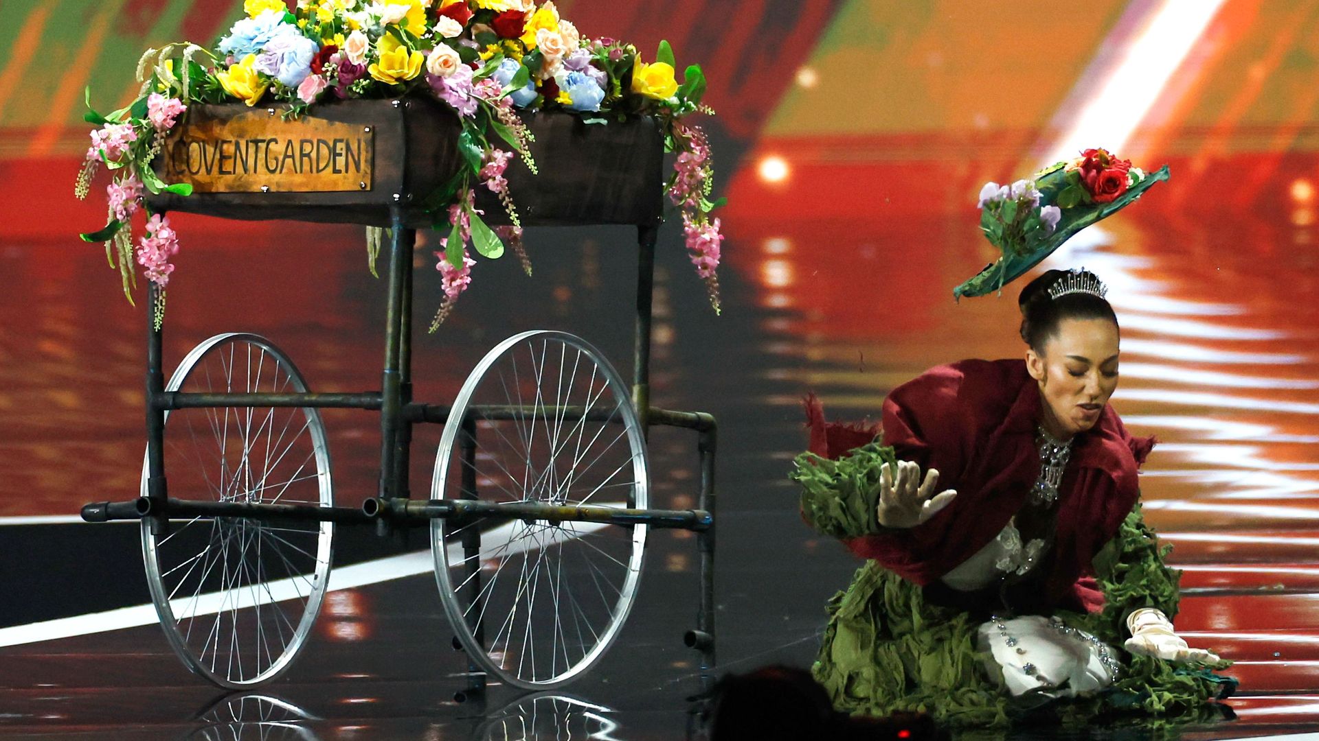 Miss Great Britain Danielle Latimer falls as she competes in the Miss Universe 2025 national costume competition