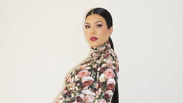 Kourtney Kardashian wears a floral dress while heavily pregnant