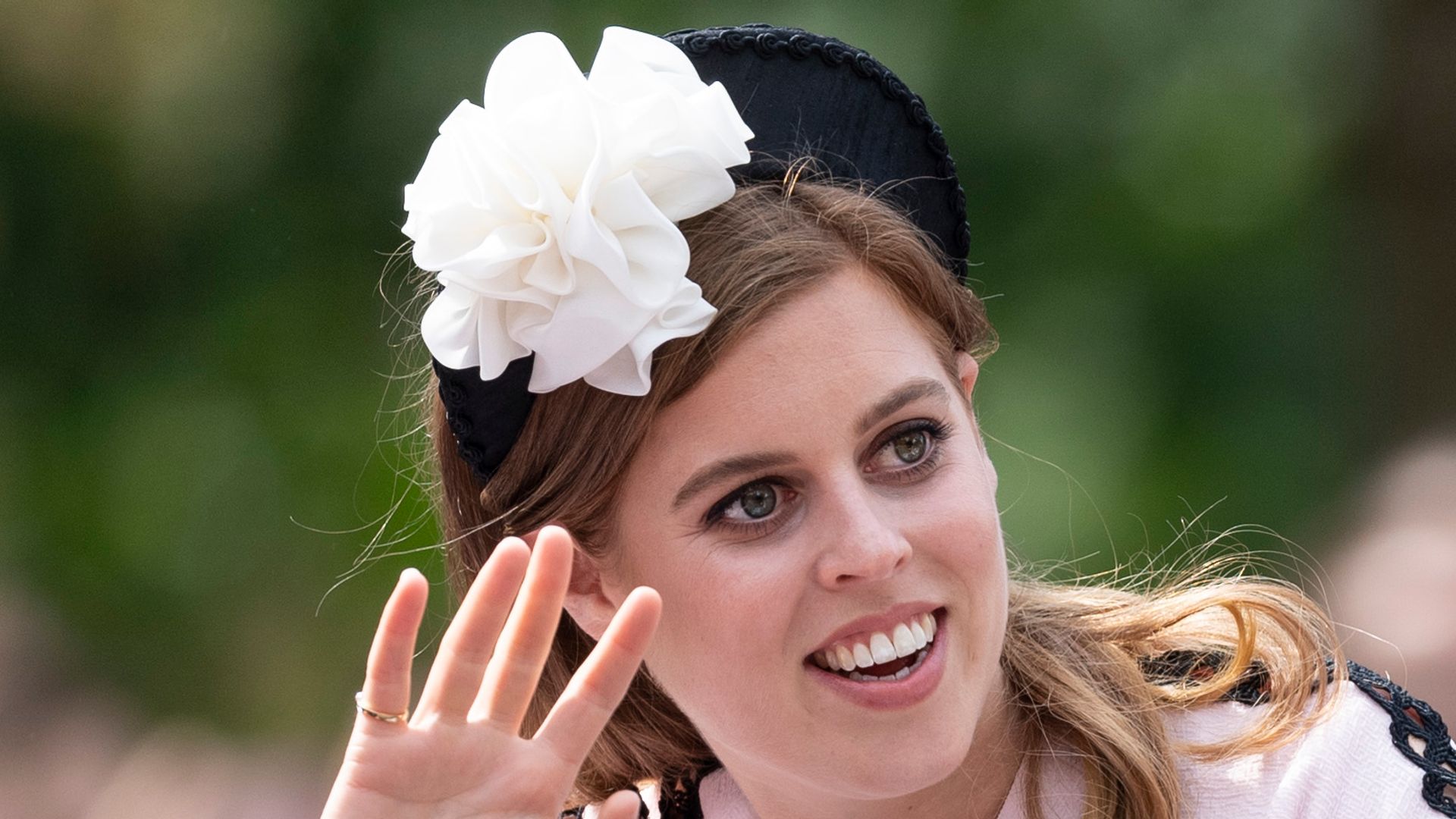 Princess Eugenie and Princess Beatrice in carriage waving
