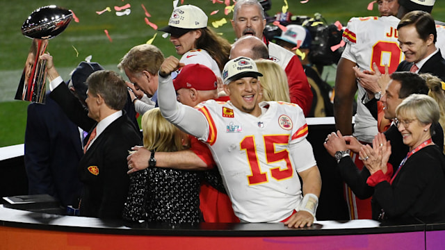 GLENDALE, ARIZONA - FEBRUARY 12: Head coach Andy Reid and quarter back Patrick Mahomes #15 of the Kansas City Chiefs stands on the podium with owner Clark Hunt celebrating with the Lombardi Trophy after they defeated the Philadelphia Eagles 38-35 in Super Bowl LVII at State Farm Stadium on February 12, 2023 in Glendale, Arizona. (Photo by Focus on Sport/Getty Images)