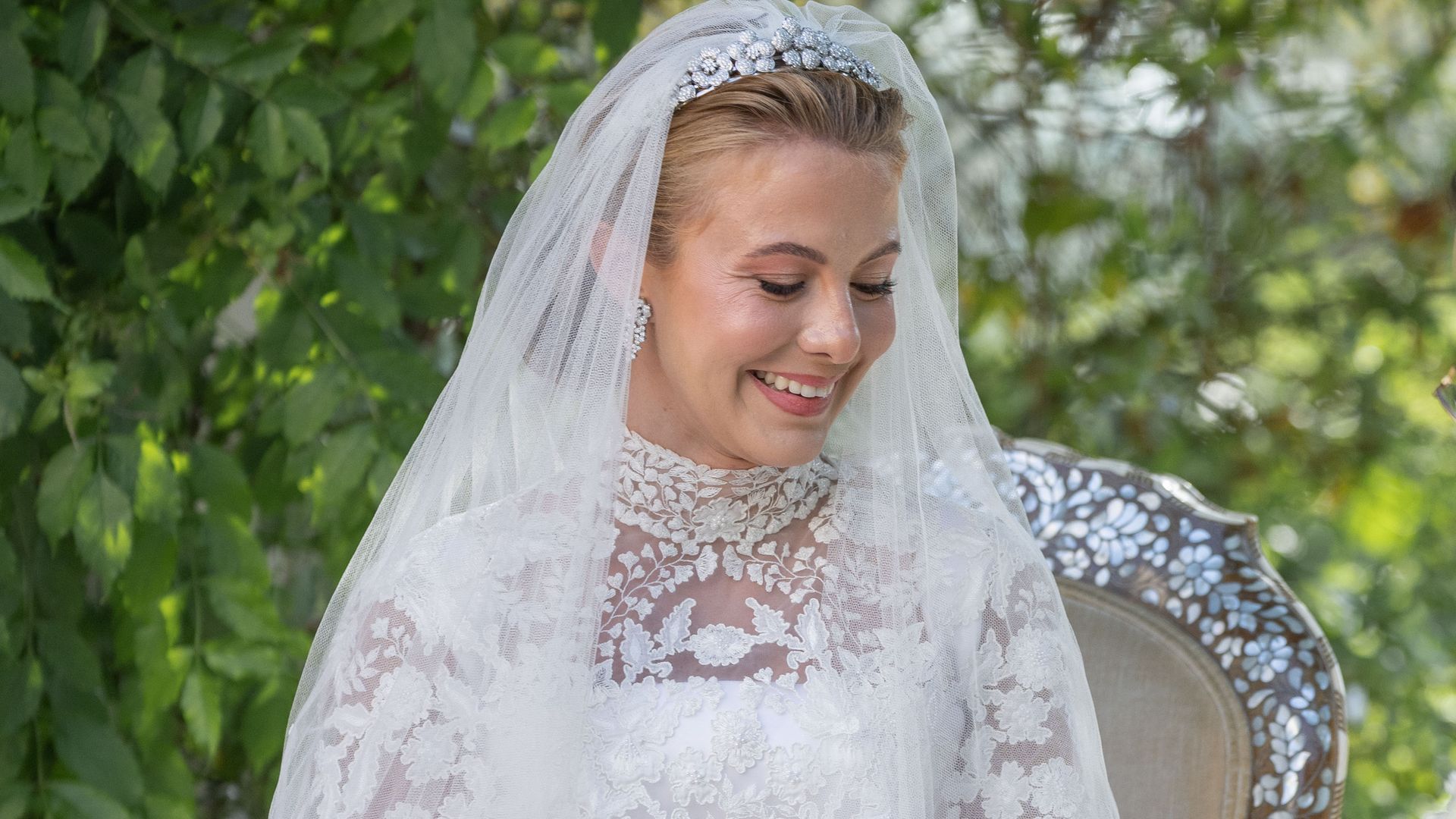 Queen Rania’s niece models corset and sheer lace bridal gown in official wedding photos