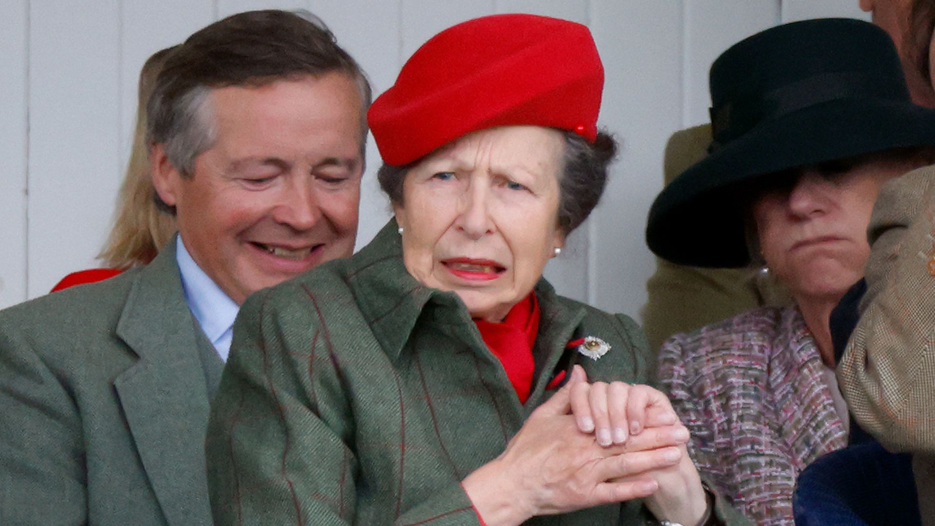 Princess Anne looking shocked in a green coat