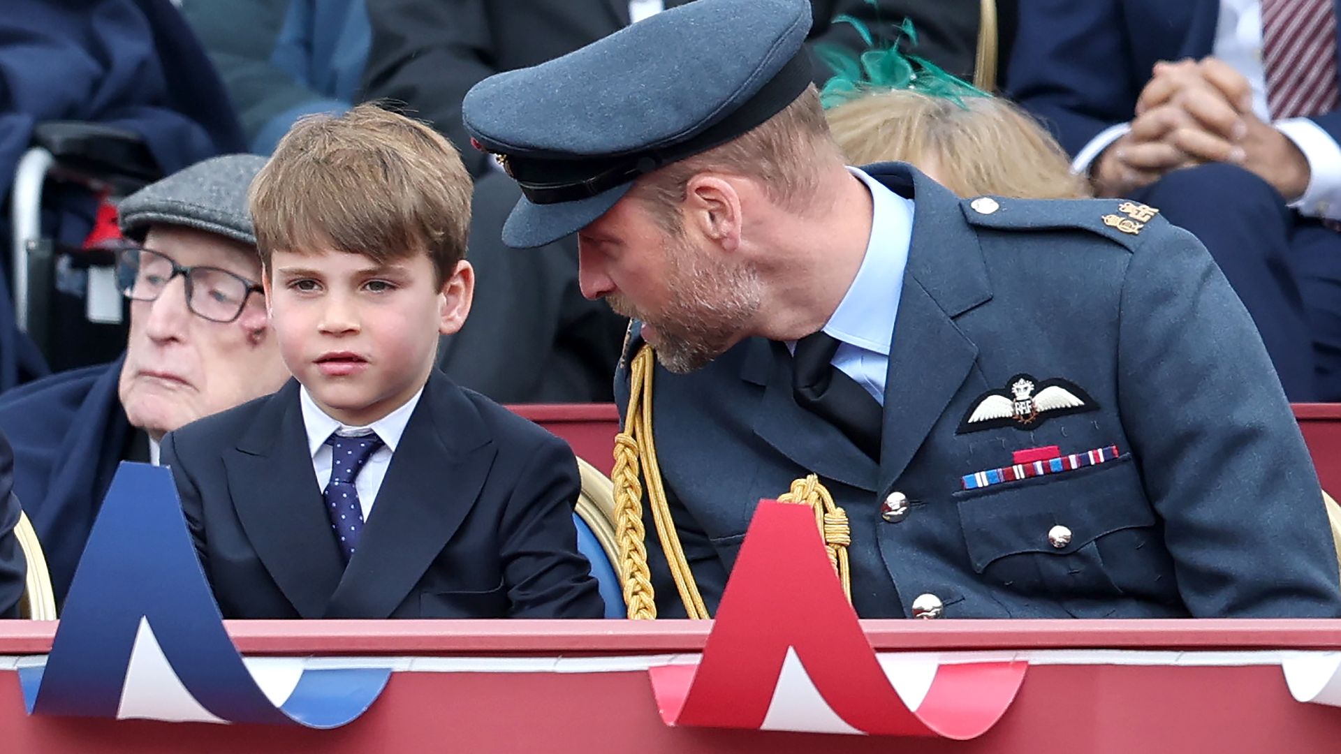 Prince William, Prince of Wales and Prince Louis sit side by side during procession on the Mall