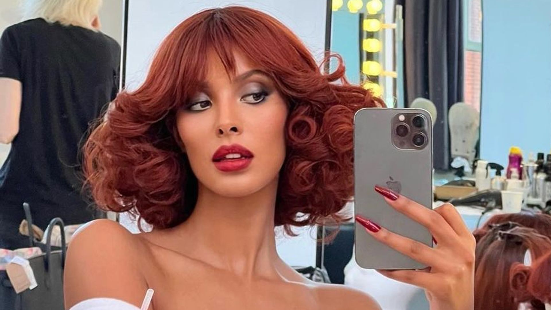 Maya Jama takes a mirror selfie with red hair