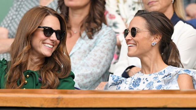 Kate Middleton smiling towards Pippa Middleton