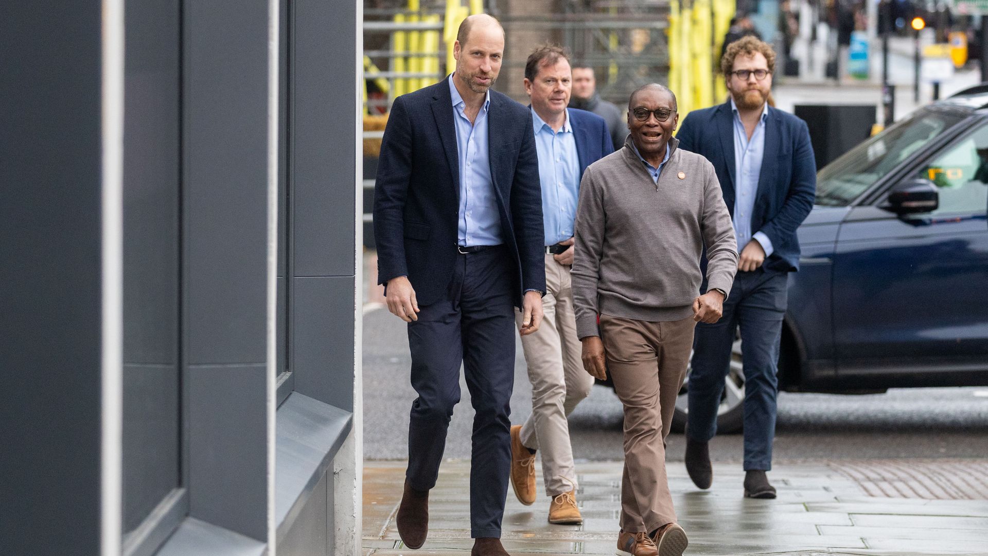 Prince William walking with three men outside Centrepoint Offices