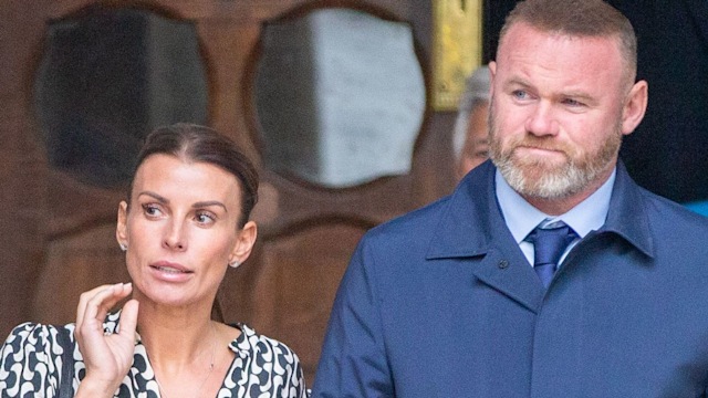 Coleen Rooney in a patterned dress with husband Wayne at Royal Courts of Justice 