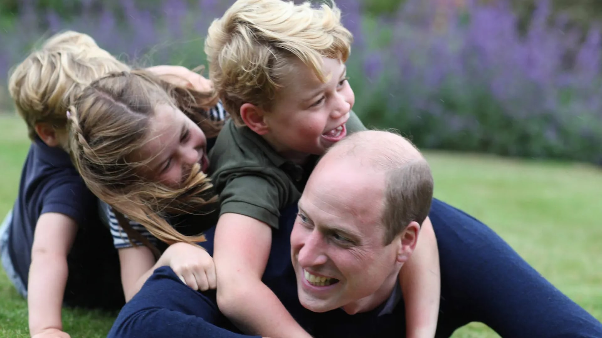prince william lying on the grass with kids