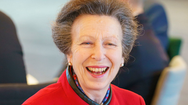 Princess Anne wearing red coat and smiling