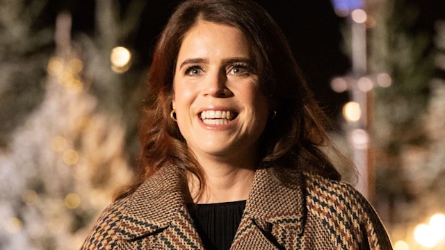 Princess Eugenie smiling in a brown overcoat