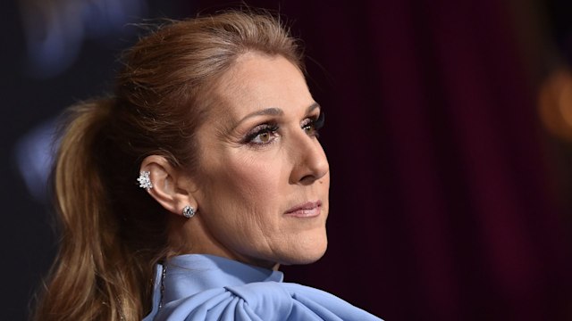 Celine Dion in a powder blue top looking serious