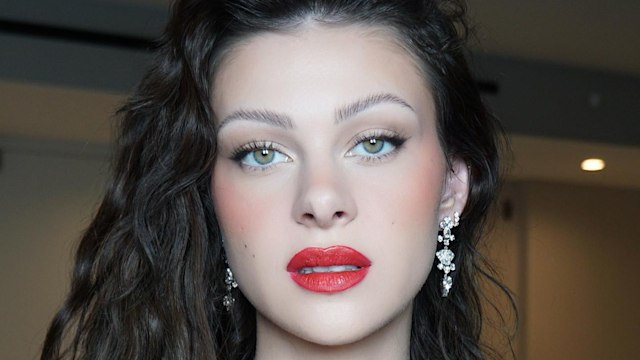 Nicola Peltz Beckham poses in a red lip look on her Instagram