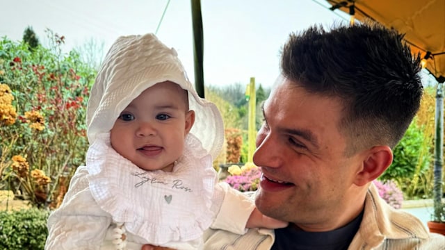 A photo of Aljaz Skorjanec holding his daughter Lrya Rose