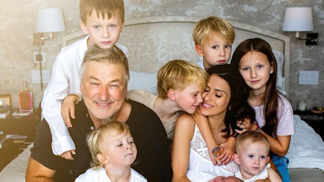 Hilaria and Alec Baldwin with children smiling in bedroom