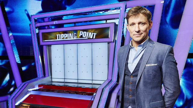 Ben Shepard posing by the Tipping Point machine
