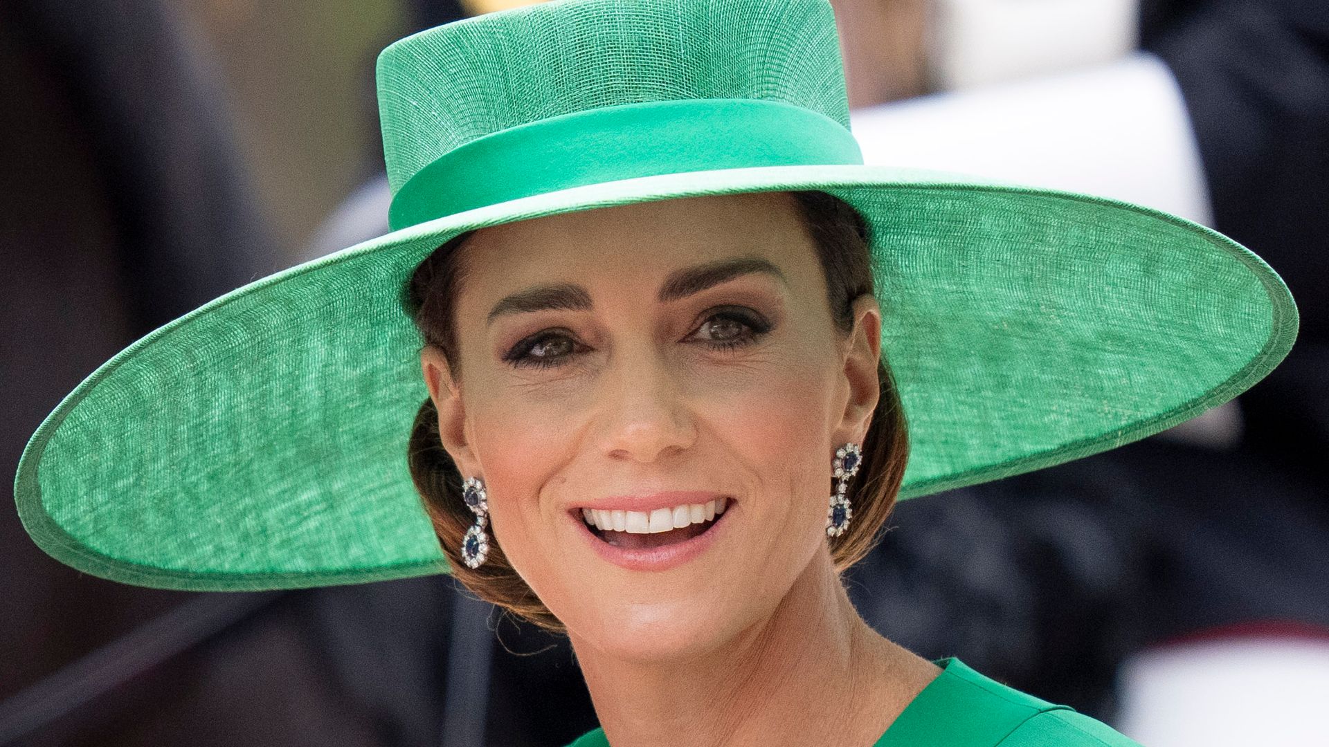 Princess Kate smiling at Trooping the Colour in her green coat dress