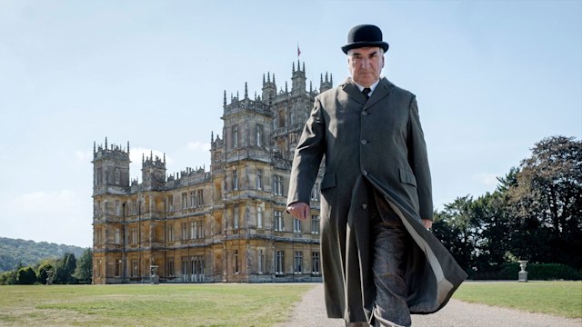 Jim Carter as Mr Carson walks outside Highclere Castle